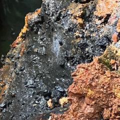 massive sulphide comprising pyrite sphalerite and chalcopyrite covered by sooty black secondary copper minerals chalcocite and covellite from the wainaleka creek discovery outcrop